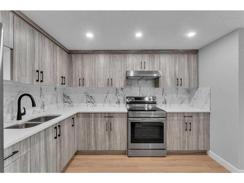 109 Kinniburgh Cove, Chestermere, AB - Indoor Photo Showing Kitchen With Double Sink