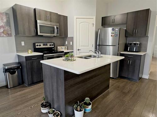 705-250 Sage Valley Road Nw, Calgary, AB - Indoor Photo Showing Kitchen With Stainless Steel Kitchen With Double Sink