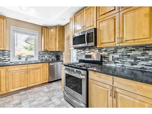 2210 23 Street, Nanton, AB - Indoor Photo Showing Kitchen With Double Sink