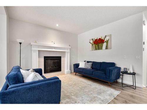 333 Clydesdale Way, Cochrane, AB - Indoor Photo Showing Living Room With Fireplace