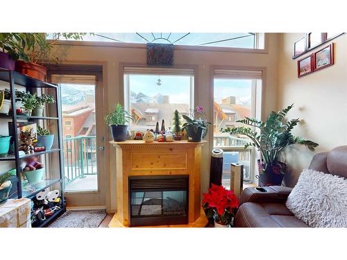 305-176 Kananaskis Way, Canmore, AB - Indoor Photo Showing Other Room With Fireplace