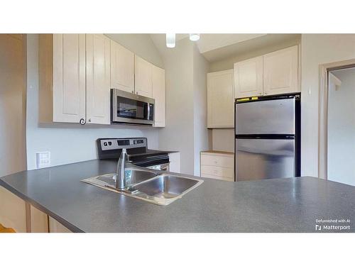 305-176 Kananaskis Way, Canmore, AB - Indoor Photo Showing Kitchen With Double Sink