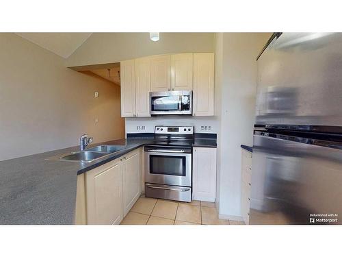 305-176 Kananaskis Way, Canmore, AB - Indoor Photo Showing Kitchen With Double Sink