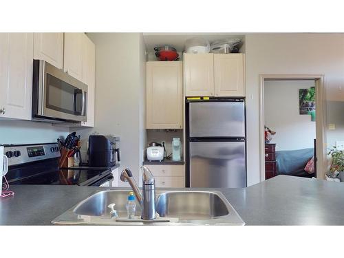 305-176 Kananaskis Way, Canmore, AB - Indoor Photo Showing Kitchen With Double Sink