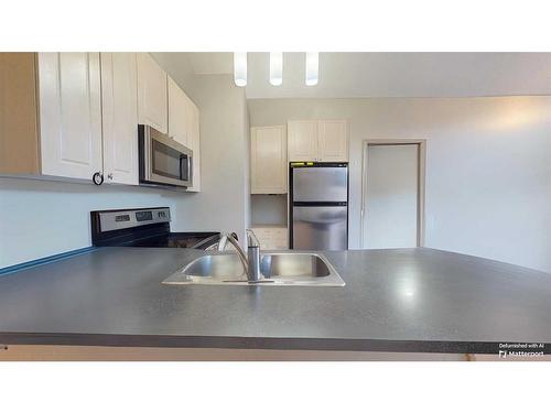 305-176 Kananaskis Way, Canmore, AB - Indoor Photo Showing Kitchen With Double Sink