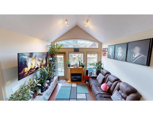 305-176 Kananaskis Way, Canmore, AB - Indoor Photo Showing Living Room With Fireplace