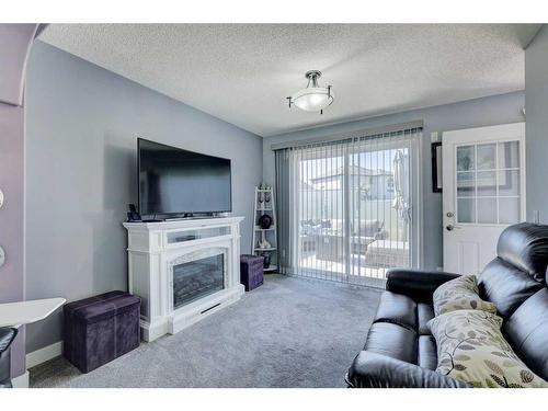 19 Woodside Crescent Nw, Airdrie, AB - Indoor Photo Showing Living Room With Fireplace