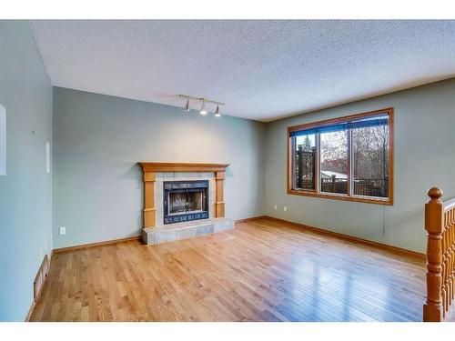 149 Shannon Crescent Sw, Calgary, AB - Indoor Photo Showing Living Room With Fireplace