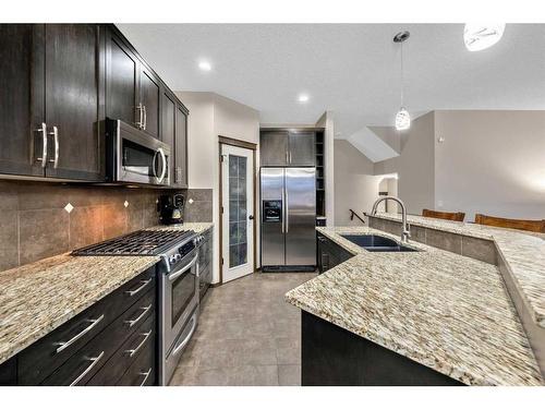 21 Silverado Range Bay Sw, Calgary, AB - Indoor Photo Showing Kitchen With Stainless Steel Kitchen With Double Sink With Upgraded Kitchen