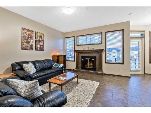 21 Silverado Range Bay Sw, Calgary, AB - Indoor Photo Showing Living Room With Fireplace