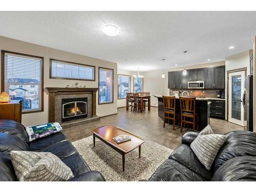 21 Silverado Range Bay Sw, Calgary, AB - Indoor Photo Showing Living Room With Fireplace