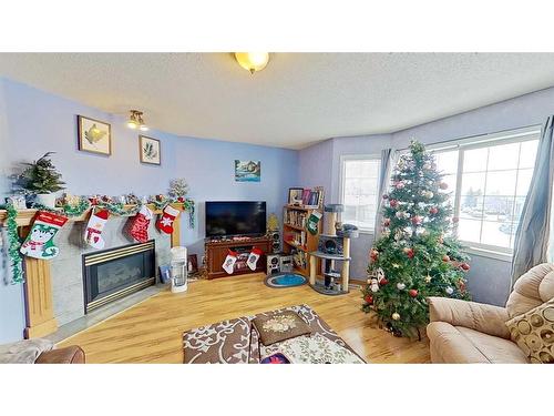 115 Coral Springs Circle Ne, Calgary, AB - Indoor Photo Showing Living Room With Fireplace