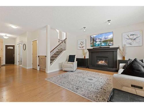 46 West Pointe Manor, Cochrane, AB - Indoor Photo Showing Living Room With Fireplace