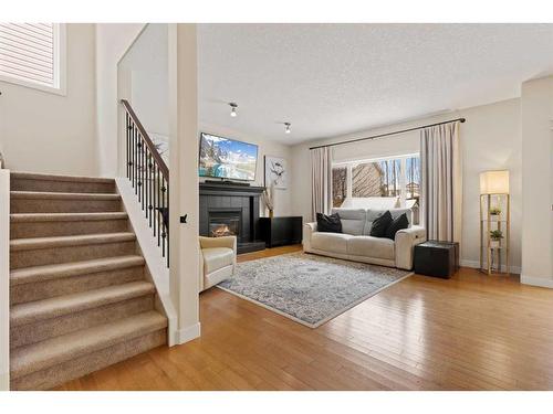 46 West Pointe Manor, Cochrane, AB - Indoor Photo Showing Living Room With Fireplace