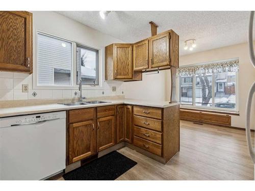 51 Sandstone Rise Nw, Calgary, AB - Indoor Photo Showing Kitchen With Double Sink