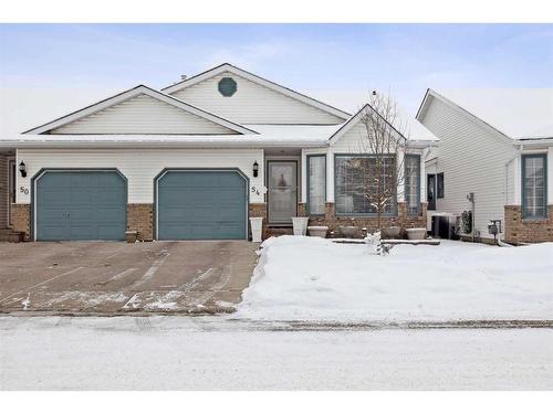 54 Rivercrest Villas Se, Calgary, AB - Outdoor With Facade