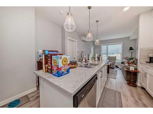 112-150 Shawnee Square Sw, Calgary, AB - Indoor Photo Showing Kitchen With Double Sink With Upgraded Kitchen