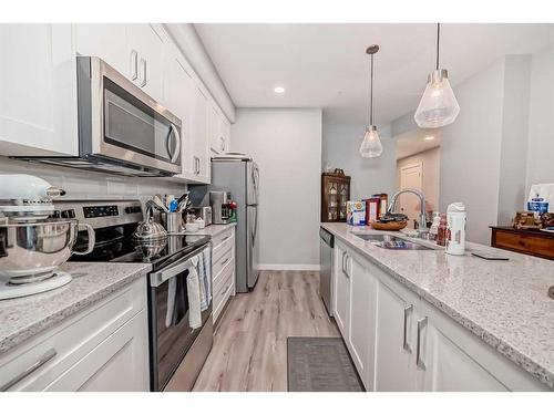 112-150 Shawnee Square Sw, Calgary, AB - Indoor Photo Showing Kitchen With Double Sink