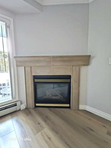 102-881 15 Avenue Sw, Calgary, AB - Indoor Photo Showing Other Room With Fireplace