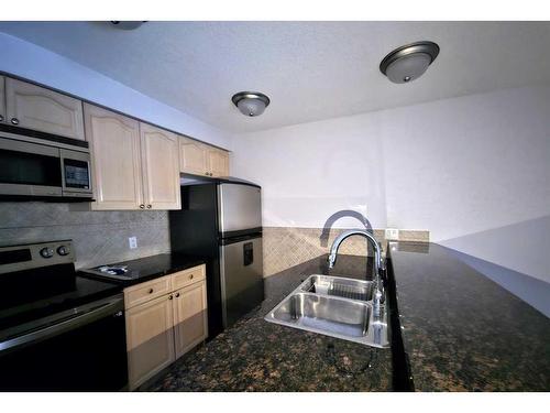 102-881 15 Avenue Sw, Calgary, AB - Indoor Photo Showing Kitchen With Stainless Steel Kitchen With Double Sink