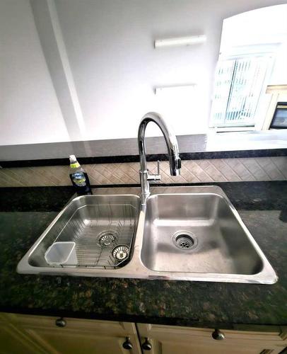 102-881 15 Avenue Sw, Calgary, AB - Indoor Photo Showing Kitchen With Double Sink