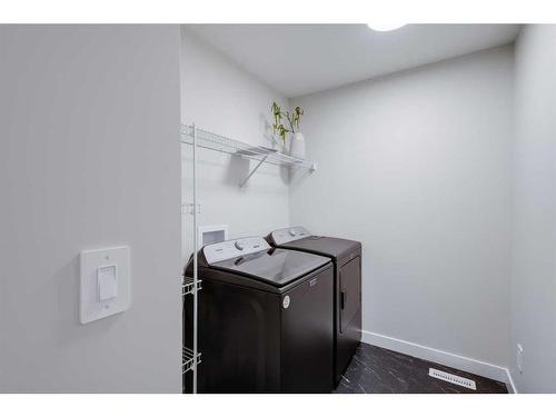 104 Sundown Crescent, Cochrane, AB - Indoor Photo Showing Laundry Room