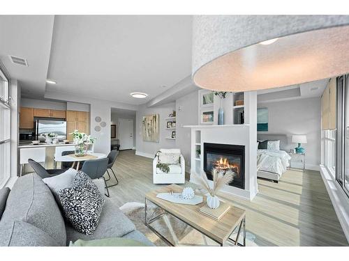 908-205 Riverfront Avenue Sw, Calgary, AB - Indoor Photo Showing Living Room With Fireplace