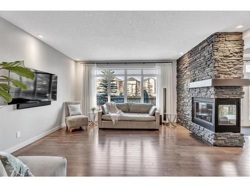 163 Cranarch Circle Se, Calgary, AB - Indoor Photo Showing Living Room With Fireplace