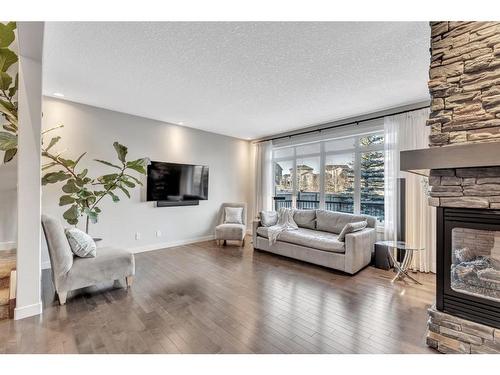 163 Cranarch Circle Se, Calgary, AB - Indoor Photo Showing Living Room With Fireplace