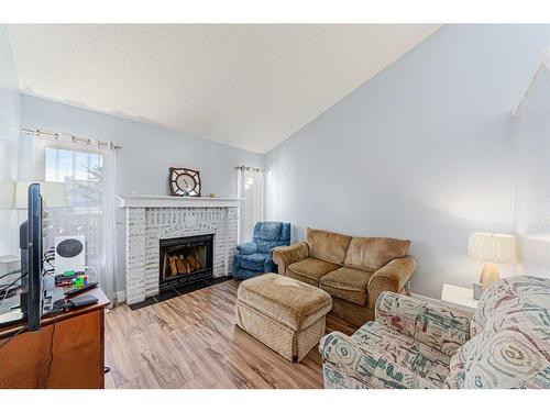 30 Hidden Crescent Nw, Calgary, AB - Indoor Photo Showing Living Room With Fireplace