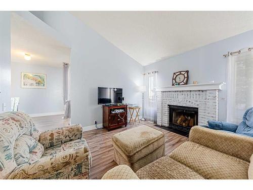 30 Hidden Crescent Nw, Calgary, AB - Indoor Photo Showing Living Room With Fireplace