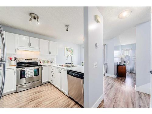 30 Hidden Crescent Nw, Calgary, AB - Indoor Photo Showing Kitchen With Stainless Steel Kitchen With Double Sink