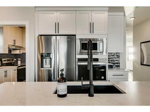 66 Ranchers View East, Okotoks, AB - Indoor Photo Showing Kitchen With Stainless Steel Kitchen With Double Sink