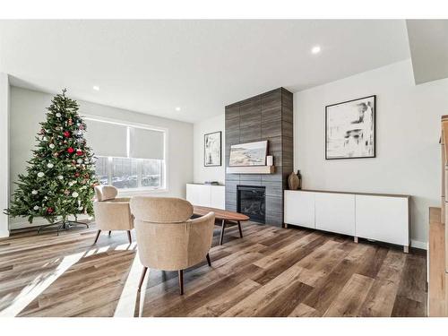 66 Precedence View, Cochrane, AB - Indoor Photo Showing Living Room With Fireplace