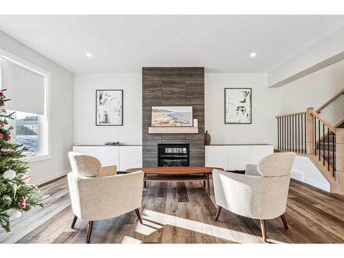 66 Precedence View, Cochrane, AB - Indoor Photo Showing Living Room With Fireplace