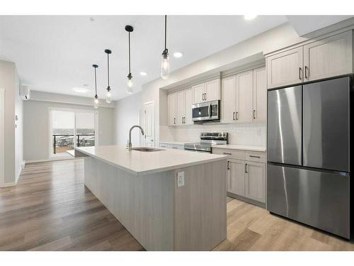 1406-42 Cranbrook Gardens Se, Calgary, AB - Indoor Photo Showing Kitchen With Stainless Steel Kitchen With Upgraded Kitchen