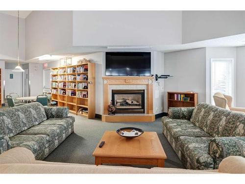 309-2309 Sienna Park Green Sw, Calgary, AB - Indoor Photo Showing Living Room With Fireplace