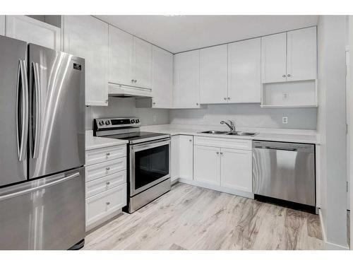 309-2309 Sienna Park Green Sw, Calgary, AB - Indoor Photo Showing Kitchen With Stainless Steel Kitchen With Double Sink