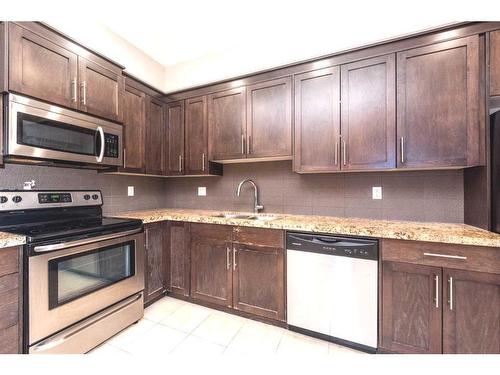 108-1005A Westmount Drive, Strathmore, AB - Indoor Photo Showing Kitchen With Double Sink