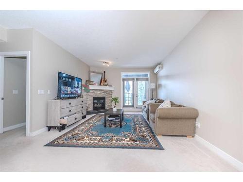 108-1005A Westmount Drive, Strathmore, AB - Indoor Photo Showing Living Room With Fireplace