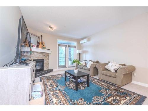 108-1005A Westmount Drive, Strathmore, AB - Indoor Photo Showing Living Room With Fireplace