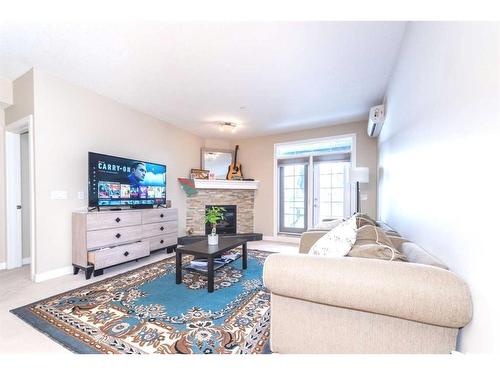 108-1005A Westmount Drive, Strathmore, AB - Indoor Photo Showing Living Room With Fireplace