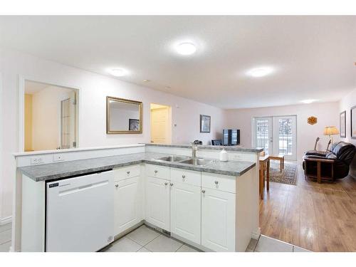 5-103 Fairways Drive Nw, Airdrie, AB - Indoor Photo Showing Kitchen With Double Sink