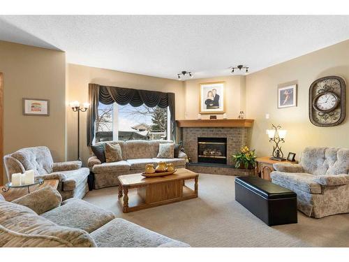 14 Eagleview Gate, Cochrane, AB - Indoor Photo Showing Living Room With Fireplace