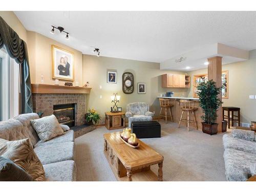 14 Eagleview Gate, Cochrane, AB - Indoor Photo Showing Living Room With Fireplace