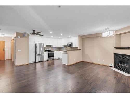 210-8535 Bonaventure Drive Se, Calgary, AB - Indoor With Fireplace