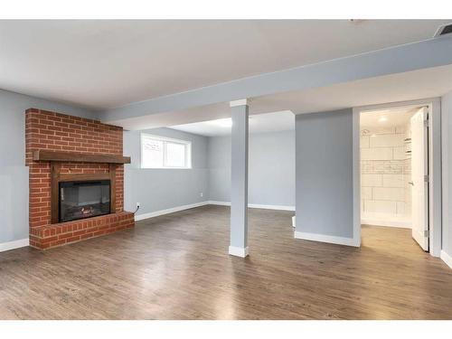 724 9Th Avenue Se, High River, AB - Indoor Photo Showing Living Room With Fireplace