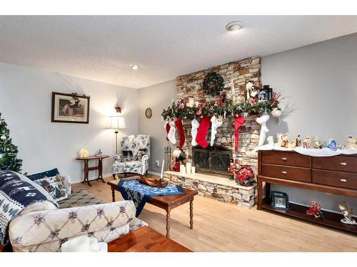 724 9Th Avenue Se, High River, AB - Indoor Photo Showing Living Room With Fireplace