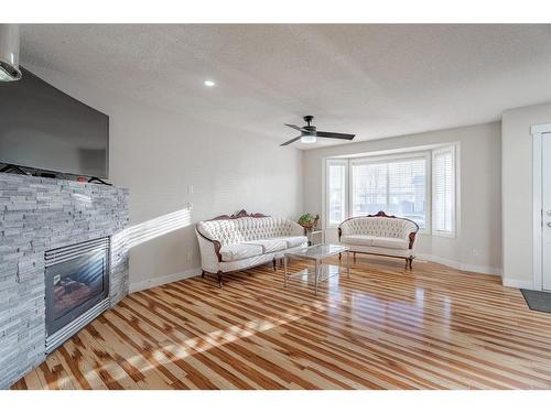 53 Martinbrook Road Ne, Calgary, AB - Indoor Photo Showing Other Room With Fireplace