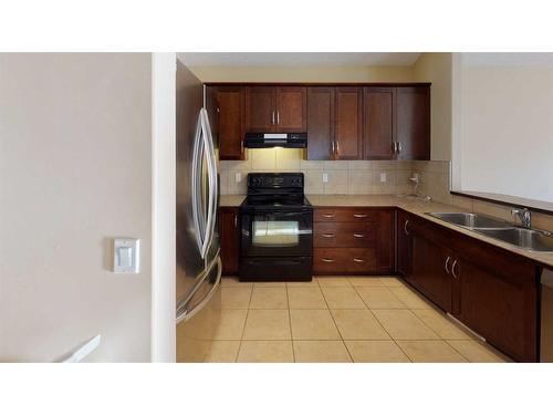 207 Cranberry Close Se, Calgary, AB - Indoor Photo Showing Kitchen With Double Sink